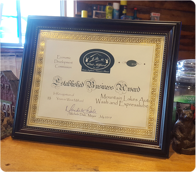 Framed business certificate on table